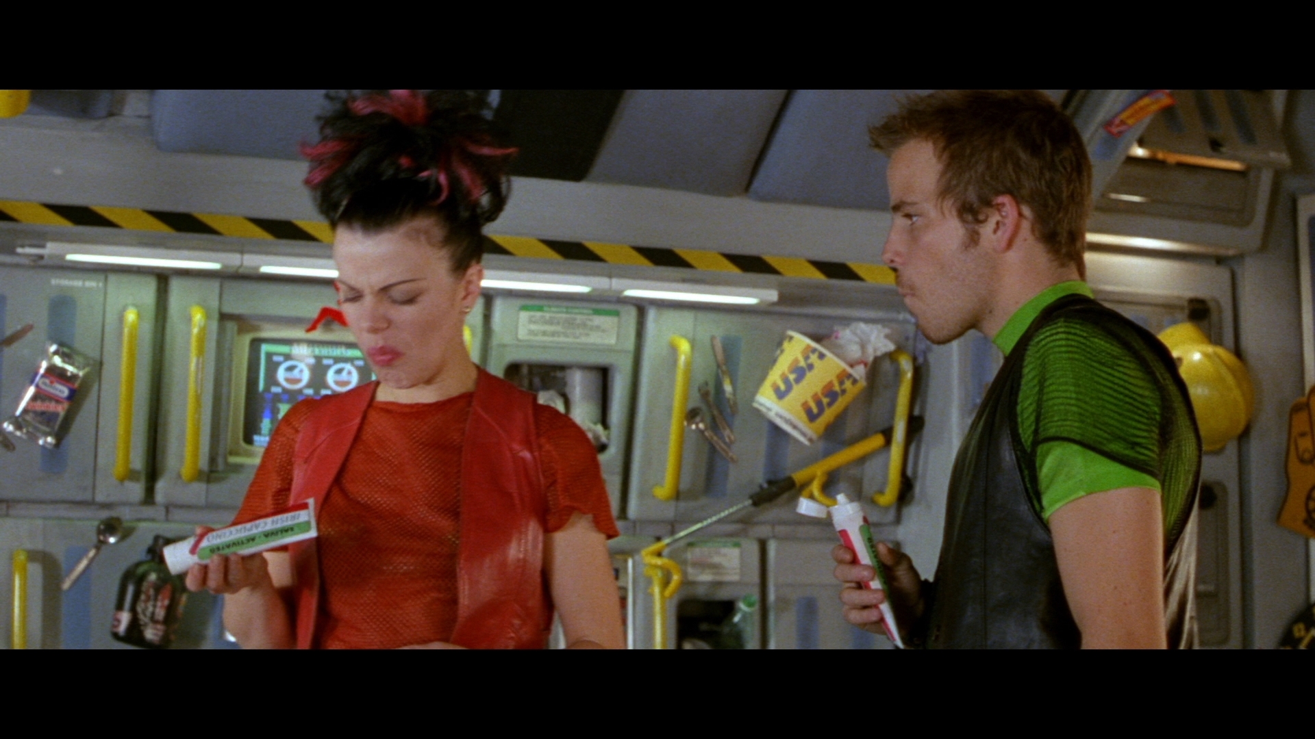 A man and a woman eat space food in the movie Space Truckers